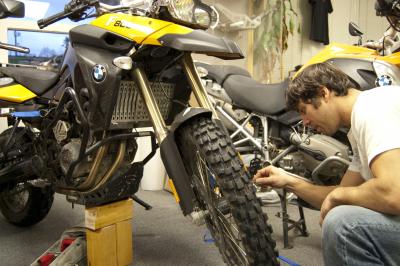 AltRider's Jeremy LeBreton removes the forks from the BMW F 800 GS to send to Ohlins USA